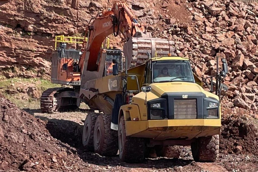 Digger loading a Rear Tipping Dumper